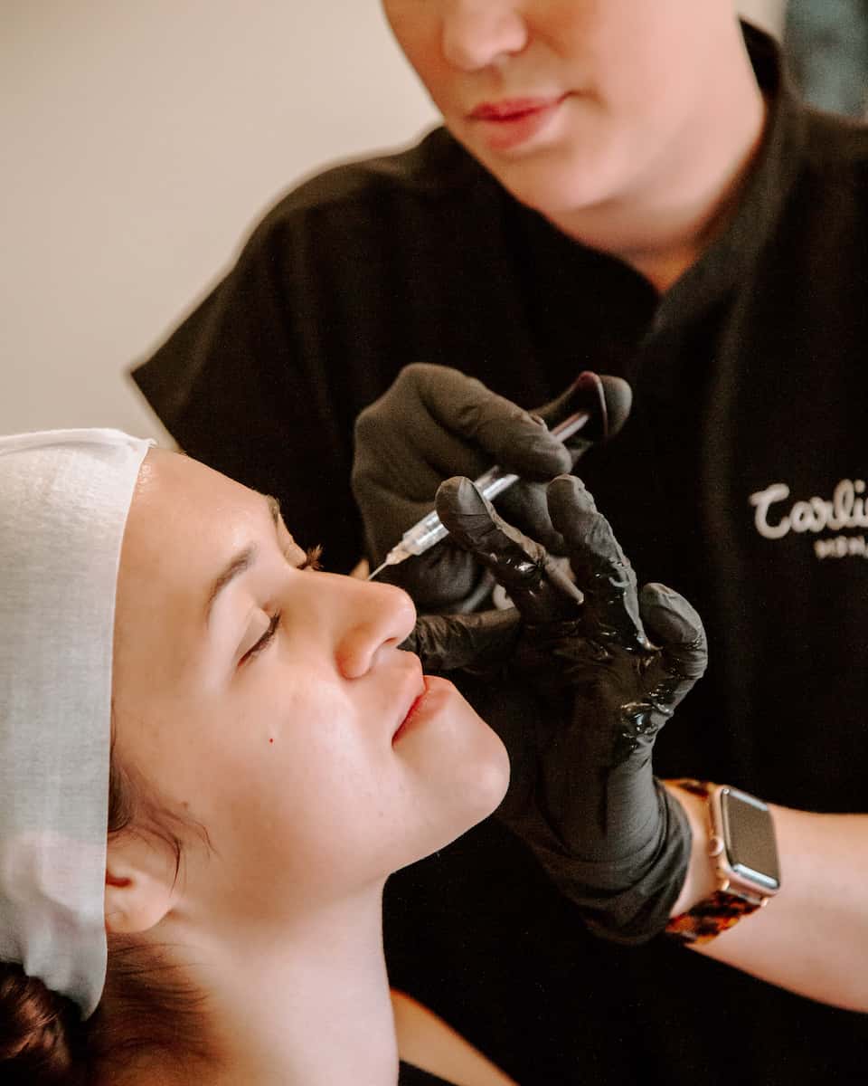 Patient getting facial injections.